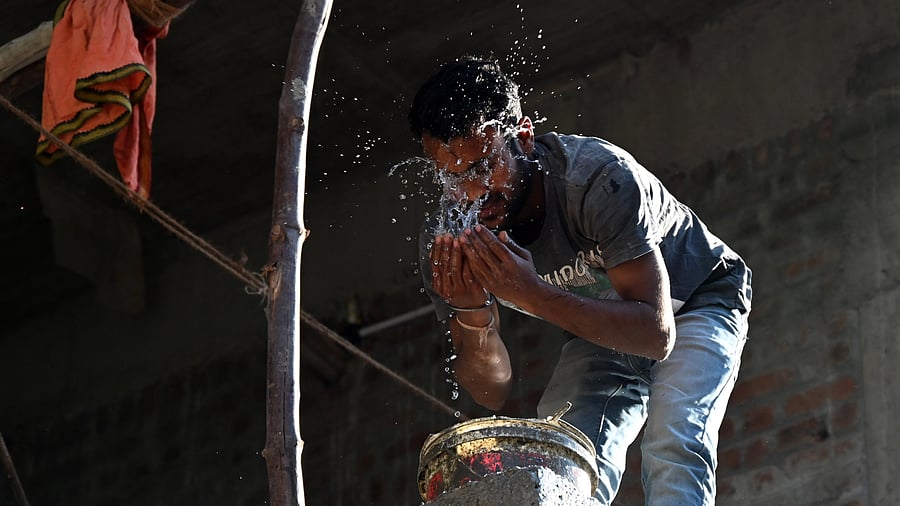 <div class="paragraphs"><p>A construction worker&nbsp;splashes water on his face&nbsp;as he tries to cool himself down on a hot summer day in Bengaluru. </p></div>