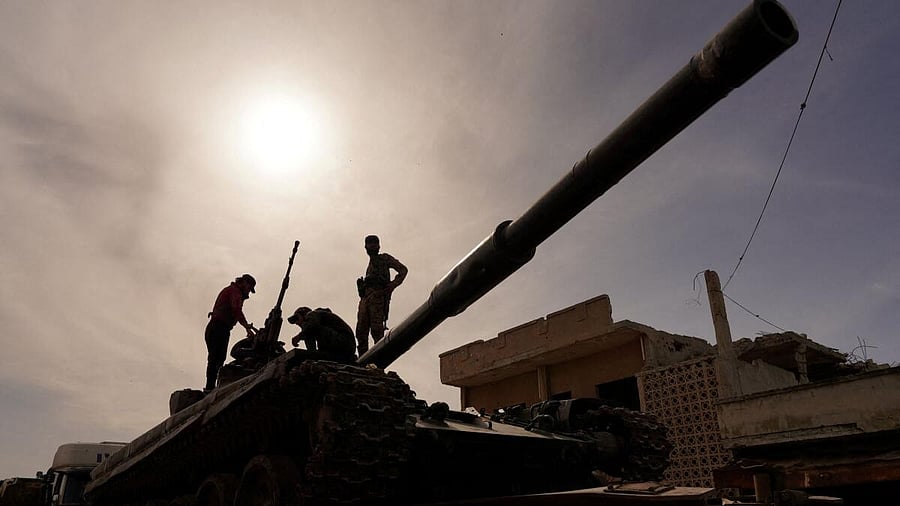 <div class="paragraphs"><p>Syrian troops sit atop a tank as they head towards the Lebanese border following clashes with soldiers.&nbsp;</p></div>