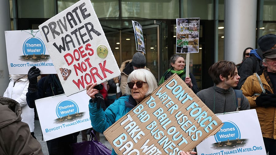 <div class="paragraphs"><p>Protestors hold placards during a demonstration opposing court approval for Thames Water's debt restructuring plan, at the High Court in London</p></div>