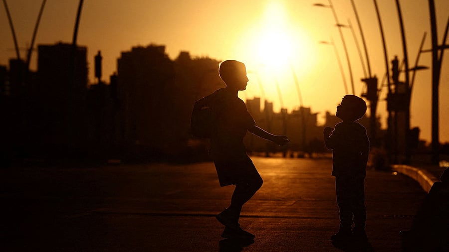 <div class="paragraphs"><p>Children play by the sea while the sun sets </p></div>
