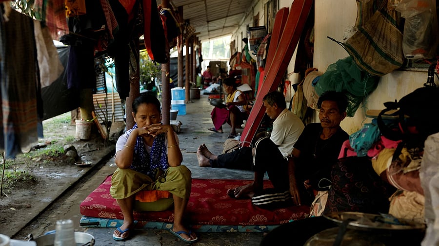 <div class="paragraphs"><p>People sit inside a relief camp for displaced Meiteis </p></div>