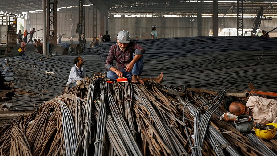 <div class="paragraphs"><p>A worker eats lunch while sitting on a pile of steel TMT bars at a small factory producing steel in Punjab, October 19, 2024. For representational purposes.</p></div>