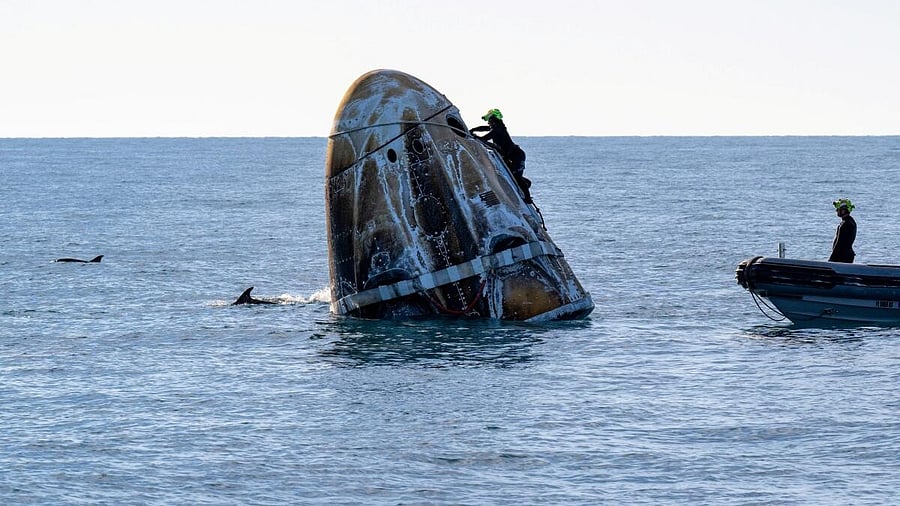<div class="paragraphs"><p>Support teams work around a SpaceX Dragon spacecraft shortly after it landed with NASA astronauts Nick Hague, Suni Williams, Butch Wilmore, and Roscosmos cosmonaut Aleksandr Gorbunov aboard in the water off the coast of Tallahassee, Florida, Tuesday, March 18, 2025</p></div>
