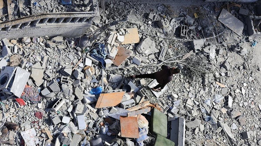 <div class="paragraphs"><p>A Palestinian walks at the site of an Israeli strike on a residential building in Gaza City, March 19, 2025.</p></div>