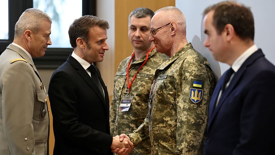 <div class="paragraphs"><p>French President Emmanuel Macron shakes hands with Colonel General Ruslan Khomchak, First Deputy Secretary of the National Security and Defence Council of Ukraine, as French Defence Minister Sebastien Lecornu and Chief of Staff of the French Armed Forces  Thierry Burkhard look on during the Paris Defence and Strategy Forum in Paris, France, March 11, 2025.</p></div>
