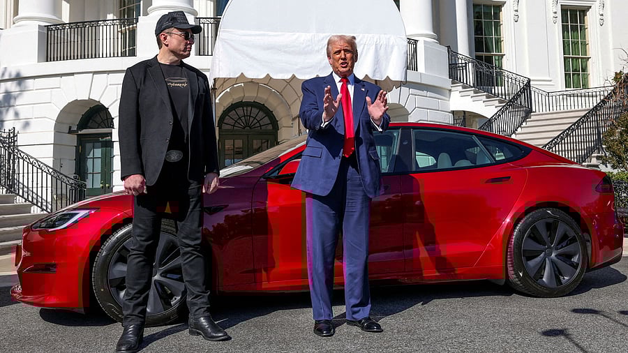 <div class="paragraphs"><p>US President Donald Trump talks to the media next to Tesla CEO Elon Musk, with a Tesla car in the background, at the White House in Washington, DC</p></div>