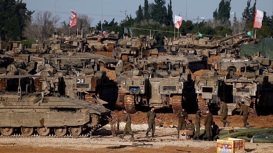 <div class="paragraphs"><p>FILE PHOTO: Israeli soldiers work by military vehicles, amid a ceasefire between Israel and Hamas, near the border with Gaza, in Israel.</p></div>