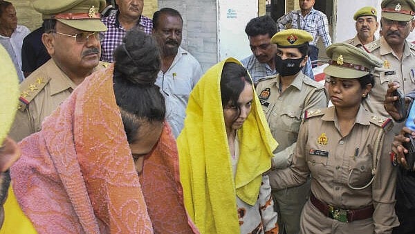 <div class="paragraphs"><p>Police take away Merchant Navy officer Saurabh Rajput's wife Muskan and her lover Sahil Shukla after they were arrested in connection with his murder, in Meerut, Wednesday, March 19, 2025. Muskan with her partner Sahil allegedly killed her husband Saurabh, dismembered his body, and sealed the body parts in a drum filled with cement.</p></div>