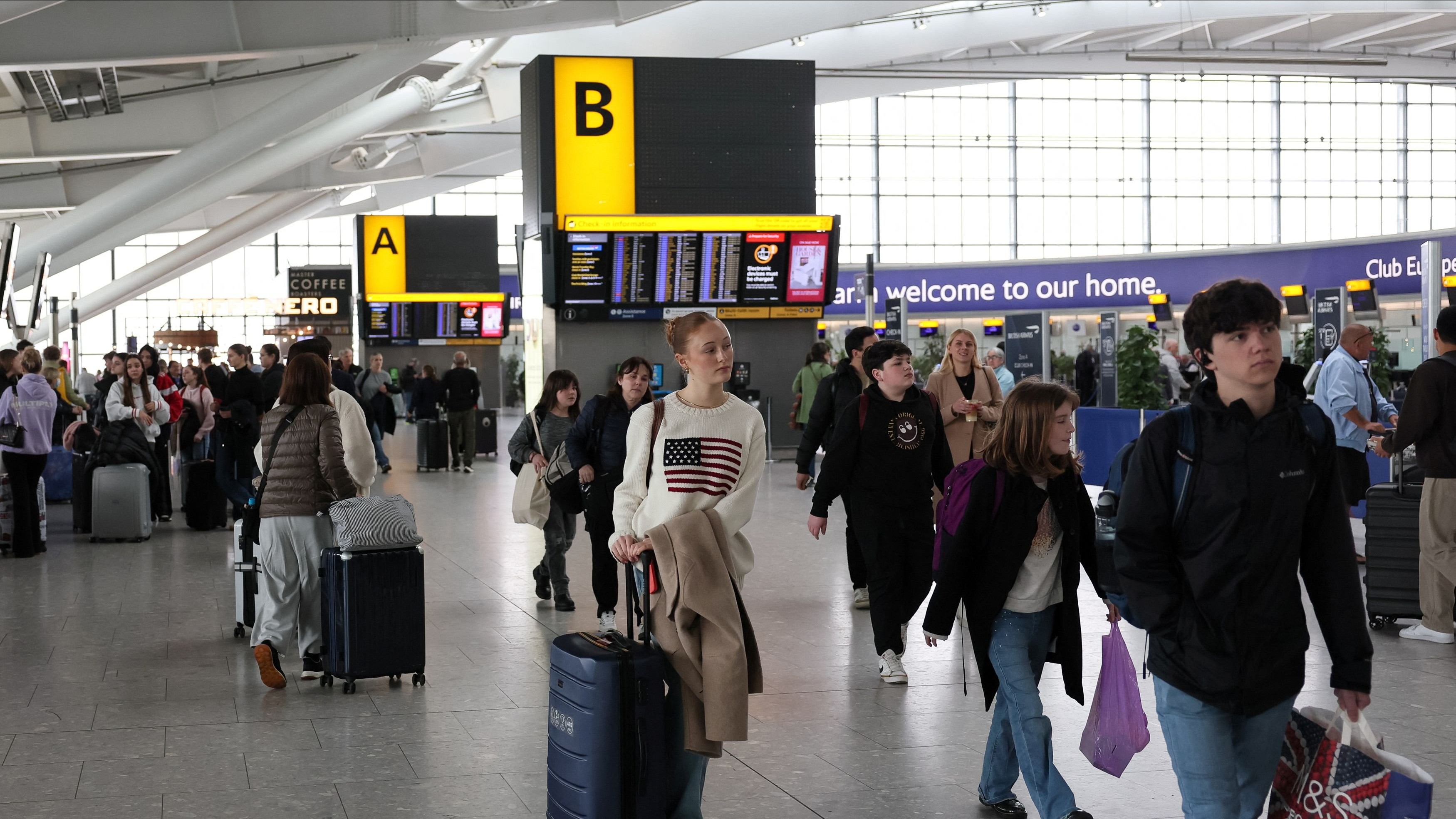 <div class="paragraphs"><p>People walk at Terminal 5 of the Heathrow International Airport, a day after a fire at a nearby electrical substation wiped out the power at the airport, near London, Britain, March 22, 2025.</p></div>