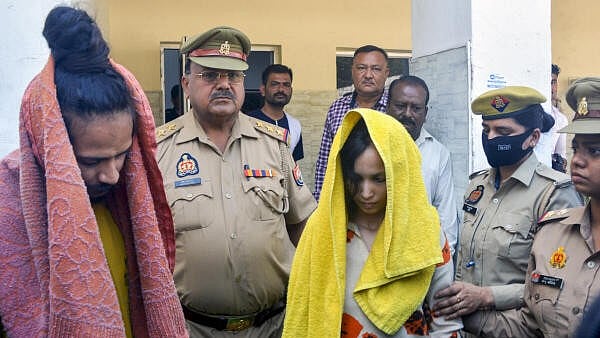 <div class="paragraphs"><p>Police take away Merchant Navy officer Saurabh Rajput's wife Muskan and her lover Sahil Shukla after they were arrested in connection with his murder, in Meerut.</p></div>