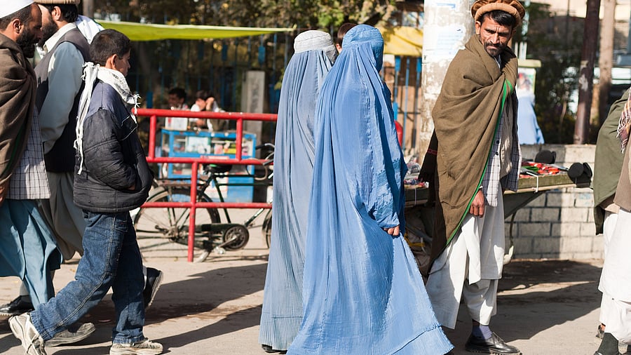 <div class="paragraphs"><p>Two women walk the streets in Afghanistan.</p></div>