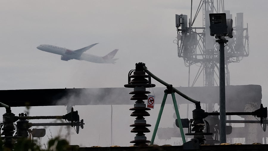 <div class="paragraphs"><p>A plane takes off, as smoke rises from an area of an electrical substation a day after it caught fire and wiped out power at Heathrow International Airport, near London, Britain.</p></div>
