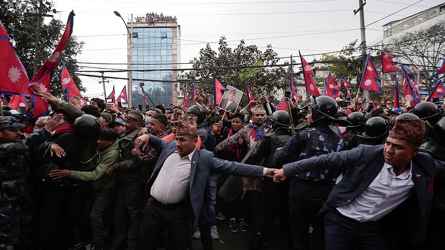 <div class="paragraphs"><p>Security personnel try to control pro-monarchy supporters demanding the restoration of monarchy in Nepal.</p></div>