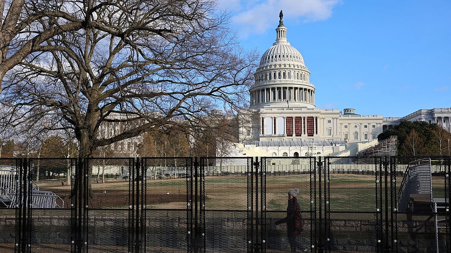 <div class="paragraphs"><p>A pedestrain walks behind the security fencing which encircles the U.S. Capitol building in Washington, US.</p></div>