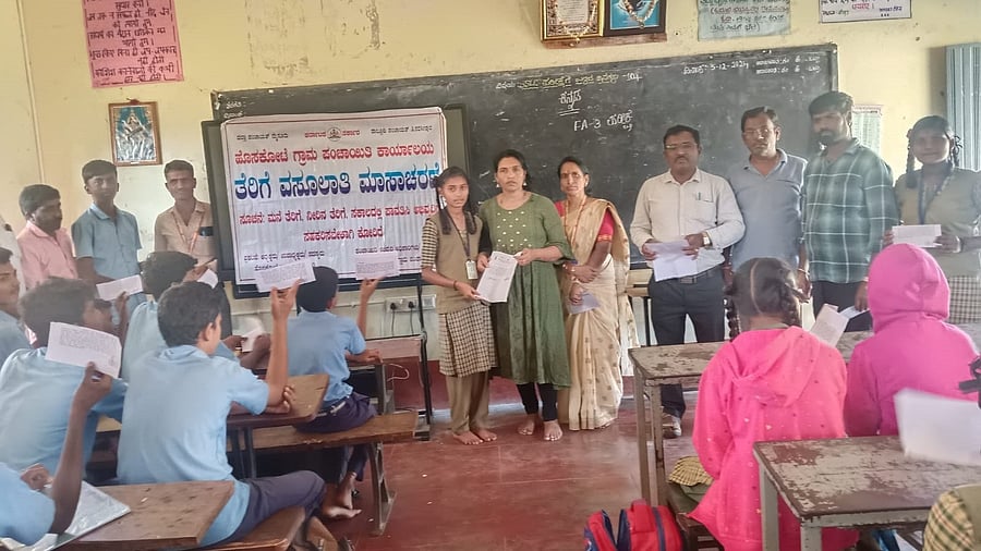 Students at the government school receive letters with information on tax payments, at an awareness programme.