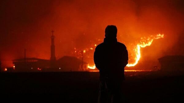 <div class="paragraphs"><p>A resident looks on as a wildfire devastates the area in Andong, South Korea.</p></div>