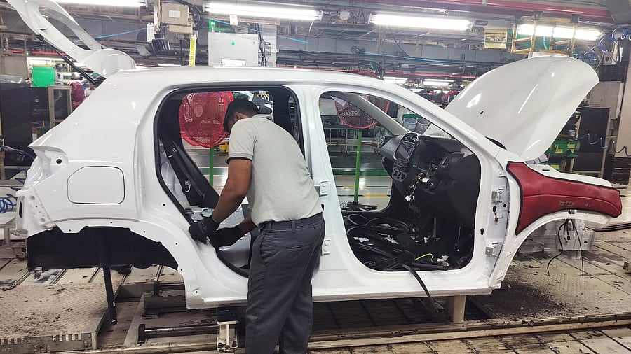 <div class="paragraphs"><p>An employee assembles different parts onto a car panel at an assembly line inside the manufacturing plant of Renault Nissan Automotive India in Oragadam, Tamil Nadu. </p></div>