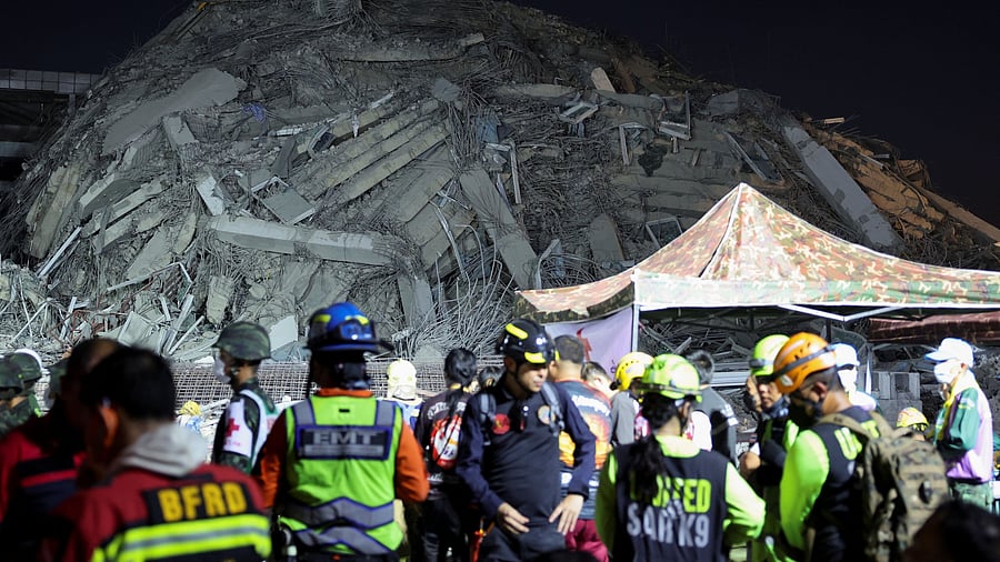 <div class="paragraphs"><p>Rescue personnel work near a building that collapsed after a strong earthquake struck central Myanmar on Friday, earthquake monitoring services said, which affected Bangkok as well with people pouring out of buildings in the Thai capital in panic after the tremors, in Bangkok, Thailand, March 28, 2025. </p></div>