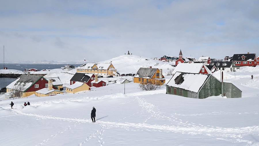 <div class="paragraphs"><p>People walk down to the sea in the old town of Nuuk, Greenland</p></div>