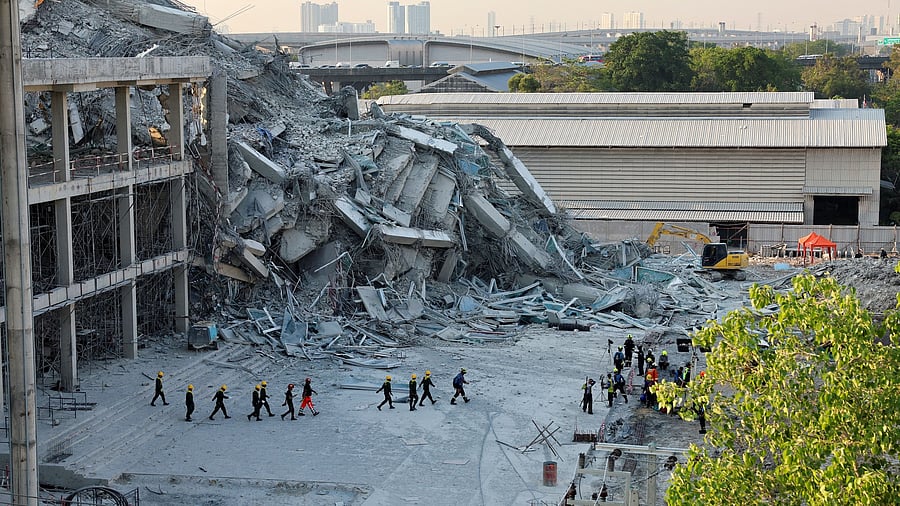 <div class="paragraphs"><p>Rescue personnel work near a building that collapsed after a strong earthquake struck central Myanmar on Friday, earthquake monitoring services said, which affected Bangkok as well with people pouring out of buildings in the Thai capital in panic after the tremors, in Bangkok, Thailand, March 28, 2025. </p></div>