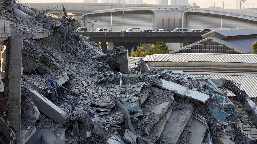 <div class="paragraphs"><p>Vehicles pass near the site of a building that collapsed after a strong earthquake struck central Myanmar on Friday, earthquake monitoring services said, which affected Bangkok as well with people pouring out of buildings in the Thai capital in panic after the tremors, in Bangkok, Thailand, March 28, 2025. </p></div>