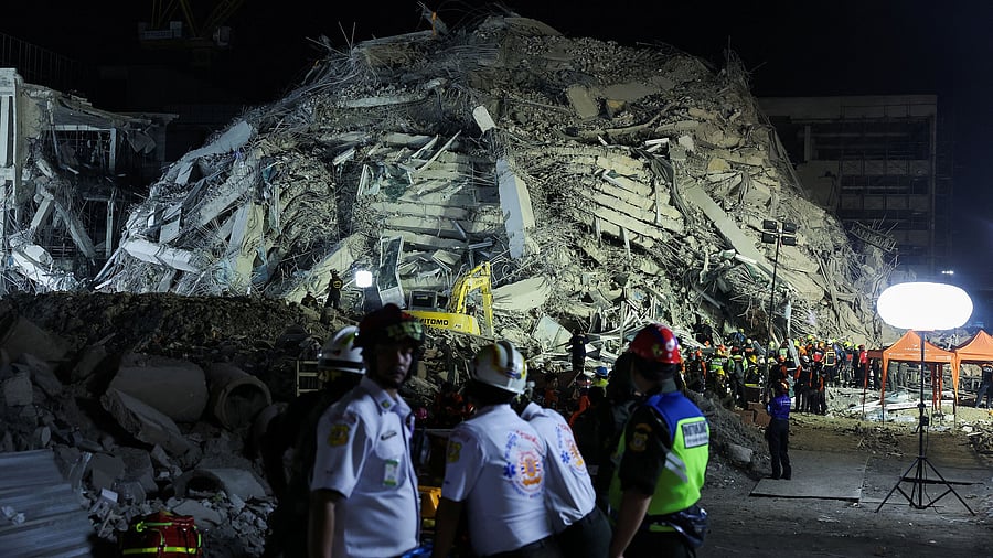 <div class="paragraphs"><p>Rescue personnel work at the site of a building that collapsed after a strong earthquake struck central Myanmar on Friday, earthquake monitoring services said, which affected Bangkok as well, with people pouring out of buildings in the Thai capital in panic after the tremors, in Bangkok, Thailand,</p></div>