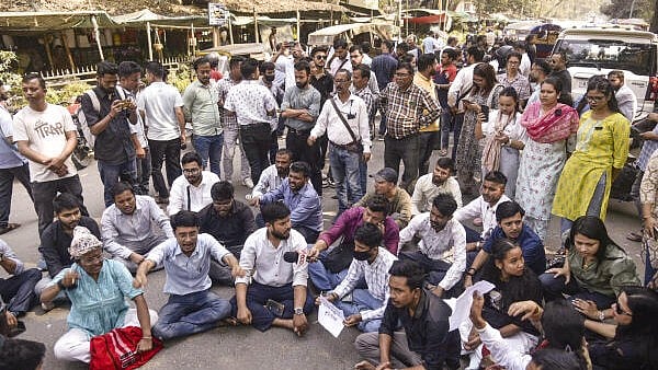 <div class="paragraphs"><p>Police personnel stage a protest against the arrest of reporter Dilwar Hussain Mozumder, outside Guwahati Press Club, in Guwahati. </p></div>