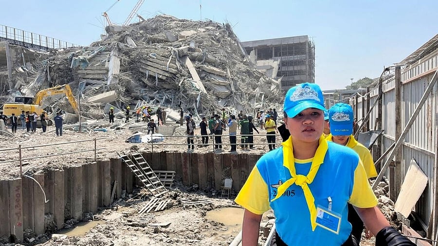 <div class="paragraphs"><p>Thai King's volunteers work near the site of a collapsed building after a strong earthquake struck central Myanmar on Friday.</p></div>