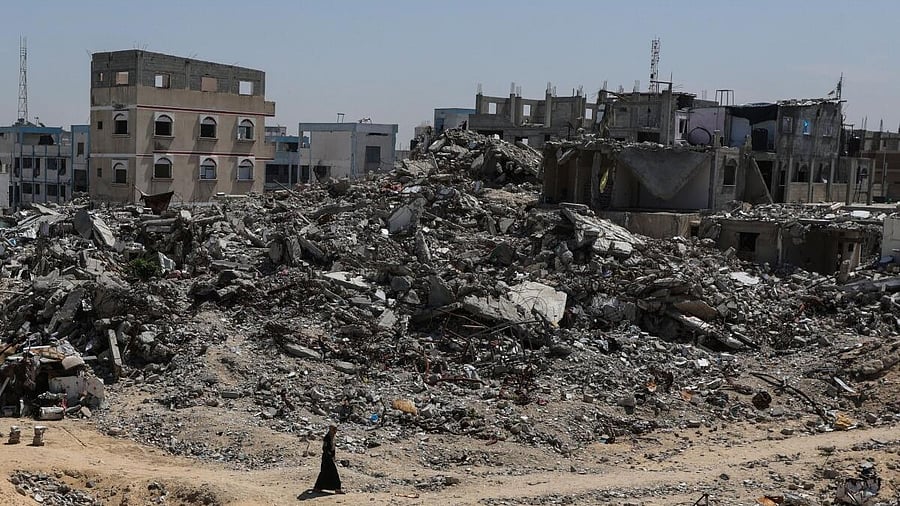 <div class="paragraphs"><p>A Palestinian walks near rubble of houses in Khan Younis, in the southern Gaza Strip, March 27, 2025.</p></div>