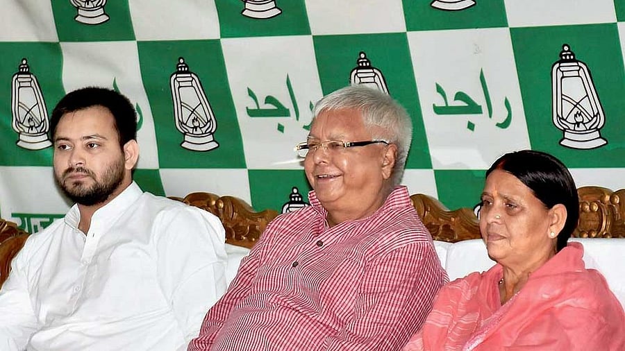 <div class="paragraphs"><p>RJD Chief Lalu Prasad Yadav with senior leader and wife Rabri Devi and  Tejashwi Yadav </p></div>
