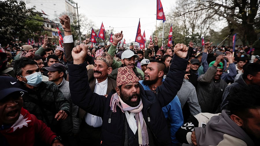 <div class="paragraphs"><p>Pro-monarchy supporters demanding the restoration of monarchy, which was abolished in 2008, chant slogans as they wait to welcome former King of Nepal Gyanendra Bir Bikram Shah Dev outside the Tribhuvan International Airport, in Kathmandu, Nepal March 9, 2025. </p></div>