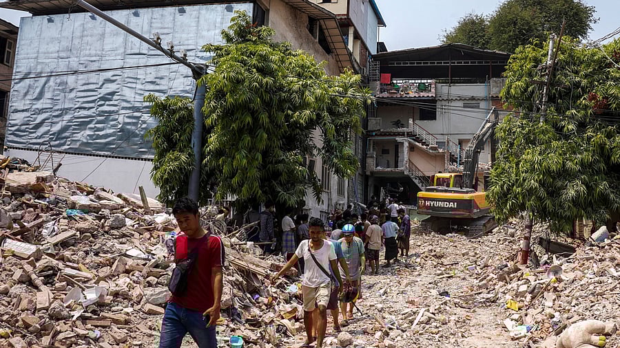 <div class="paragraphs"><p>People walk amid rubble as search and rescue operations continue in the aftermath of a strong earthquake, in Mandalay, Myanmar, March 30, 2025. </p></div>