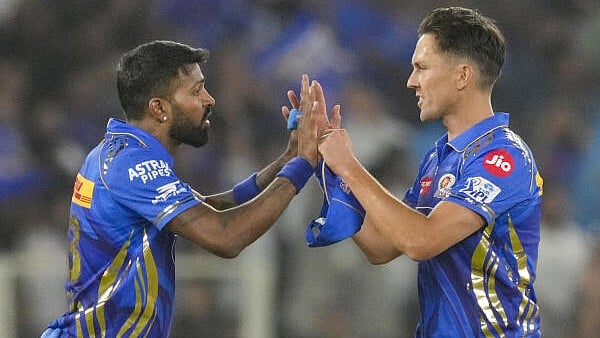 <div class="paragraphs"><p>Mumbai Indians' Trent Boult celebrates with captain Hardik Pandya after taking the wicket of Gujarat Titans' Sai Sudharsan during an Indian Premier League (IPL) 2025 T20 cricket match between Gujarat Titans and Mumbai Indians, at the Narendra Modi Stadium, in Ahmedabad, Saturday.&nbsp;</p></div>