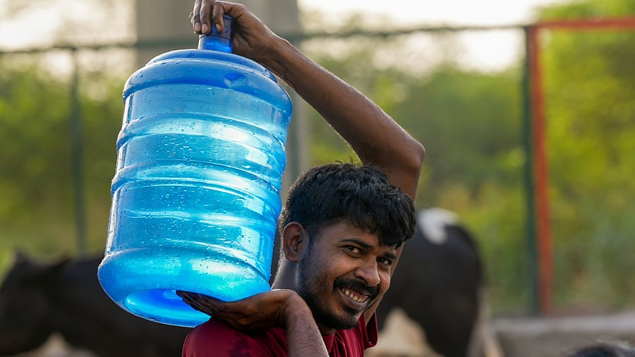 <div class="paragraphs"><p>A man carries drinking water collected from a tanker.</p></div>