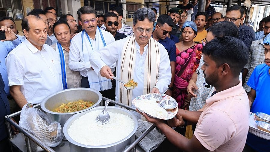 <div class="paragraphs"><p>Manik Saha serves meal as part of the new scheme on Monday. </p></div>
