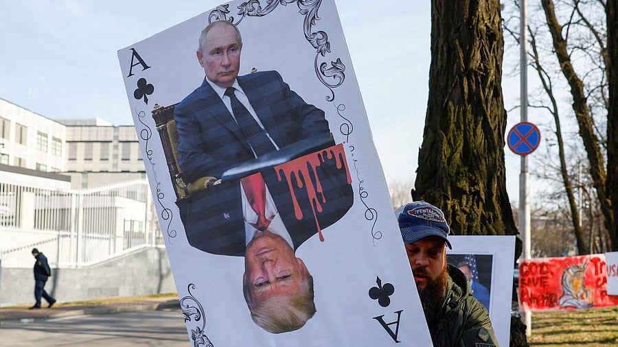 <div class="paragraphs"><p>A demonstrator holds a banner depicting a playing card with portraits of Russian President Vladimir Putin and U.S. President Donald Trump during a rally against Trump's stance on the Russia-Ukraine war, amid Russia's attack on Ukraine, in front of the U.S. embassy in Kyiv, Ukraine March 8, 2025. </p></div>