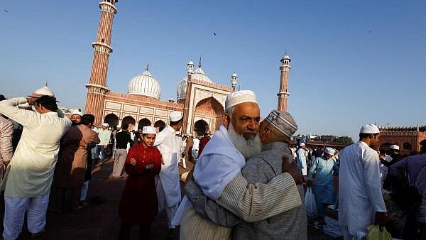 <div class="paragraphs"><p>Muslim men greet each other on the occasion of Eid al-Fitr at Jama Masjid, in the old quarters of Delhi.</p></div>