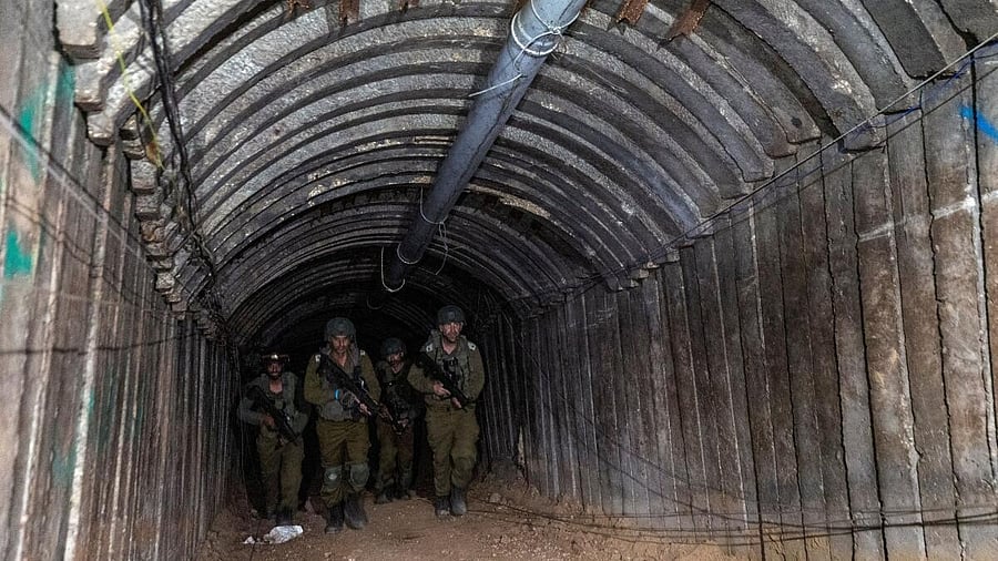 <div class="paragraphs"><p>Israeli soldiers walk through what their military says is an iron-girded tunnel designed by Hamas to disgorge carloads of Palestinian fighters for a surprise storming of the border, amid their ongoing ground operation. </p></div>