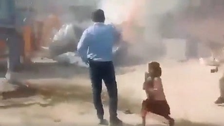 <div class="paragraphs"><p>In pic: A girl clutching her books and running away as a bulldozer razes her house.</p></div>