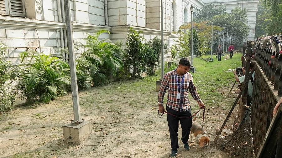 <div class="paragraphs"><p>File photo of bomb disposal squad personnel with a sniffer dog conducts a search at the Indian Museum following a bomb threat in Kolkata.</p></div>
