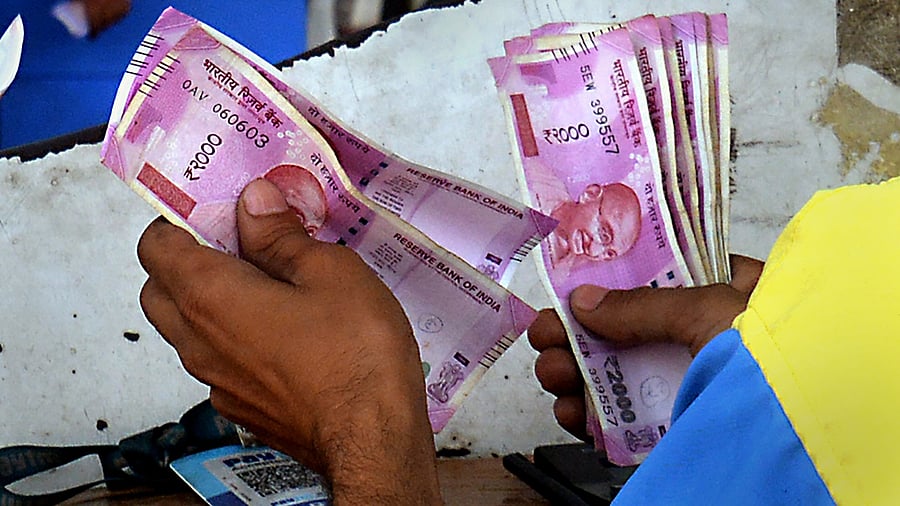 <div class="paragraphs"><p>An employee counts Rs 2000 currency notes given by customers at a petrol pump in Ghaziabad. (Image for representation)&nbsp;</p></div>