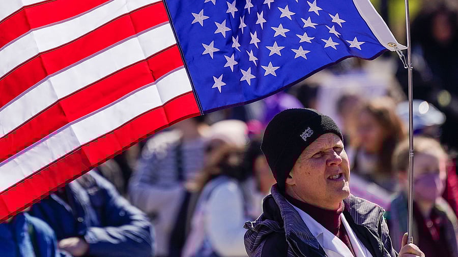 <div class="paragraphs"><p>A demonstrator holds an upside-down US flag in response to US President Donald Trump's administration cuts and layoffs at federal agencies sponsoring medical research, at the Lincoln Memorial in Washington.</p></div>