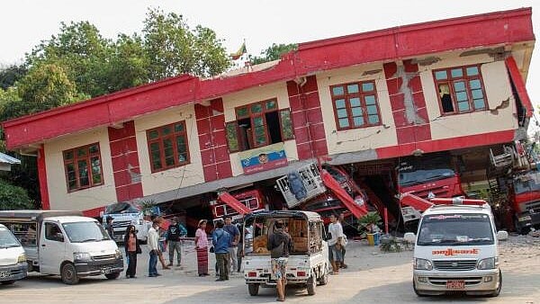 <div class="paragraphs"><p>People stand by a collapsed fire station after a strong earthquake, near its epicenter, in Sagaing, Myanmar.</p></div>