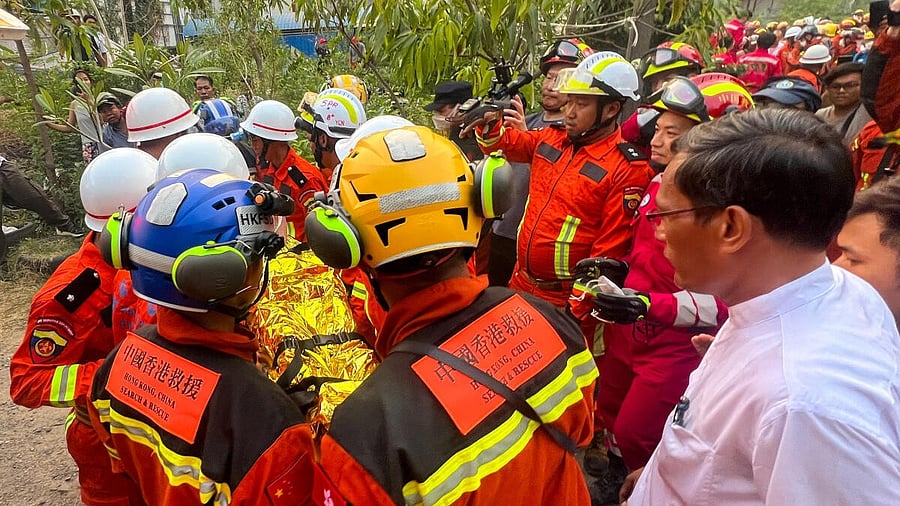 <div class="paragraphs"><p>Chinese rescue workers carry a survivor trapped inside the Golden Country Hotel following a strong earthquake in Mandalay, Myanmar.</p></div>