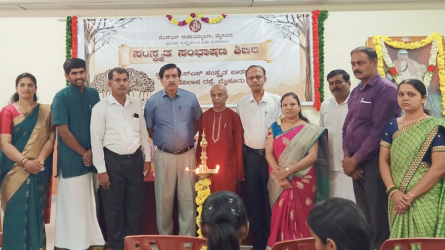 <div class="paragraphs"><p>Sanskrit scholar and journalist Srivathsa Acharya inaugurates the Sanskrit conversation camp, organised by KSS Sanskrit Patashale in Mysuru, on Wednesday. Head of Akashvani Mysuru S Umesh, Education Officer of JSS MVP Renuswamy, principal of JSS Sanskrit College K B Mallikarjuna, headmistress of patashale S L Komala and teacher Srikrishna Ganapathi Bhat are seen.</p></div>