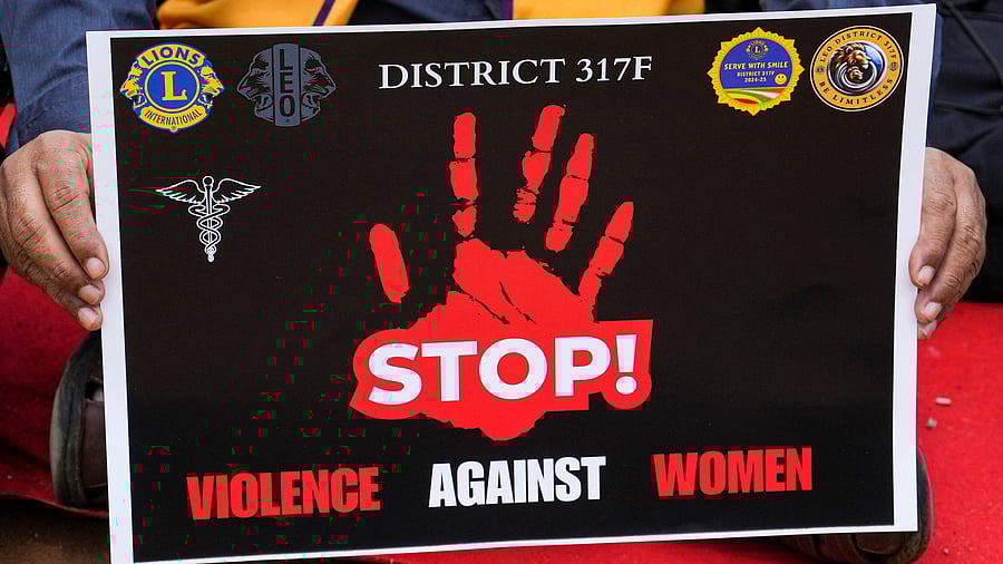 <div class="paragraphs"><p>A 'stop violence against women' poster is seen</p></div>