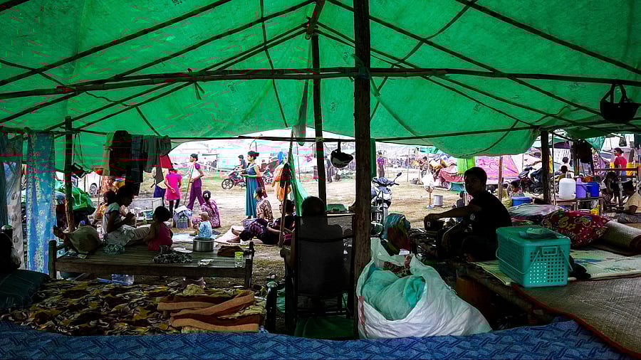 <div class="paragraphs"><p>People are seen inside a shelter in a makeshift tent camp following a strong earthquake in Amarapura township, Myanmar, </p></div>