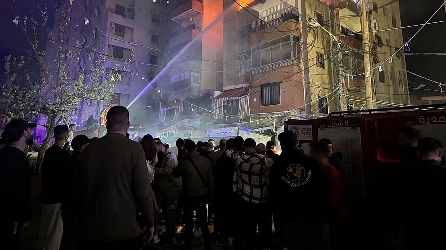 <div class="paragraphs"><p>Firefighters try to put off fire at a building following an Israeli strike, in which the Israeli military said, it killed Hamas commander Hassan Farh.</p></div>