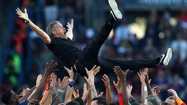 <div class="paragraphs"><p>Paris St Germain coach Luis Enrique celebrates with the players after winning Ligue.</p></div>