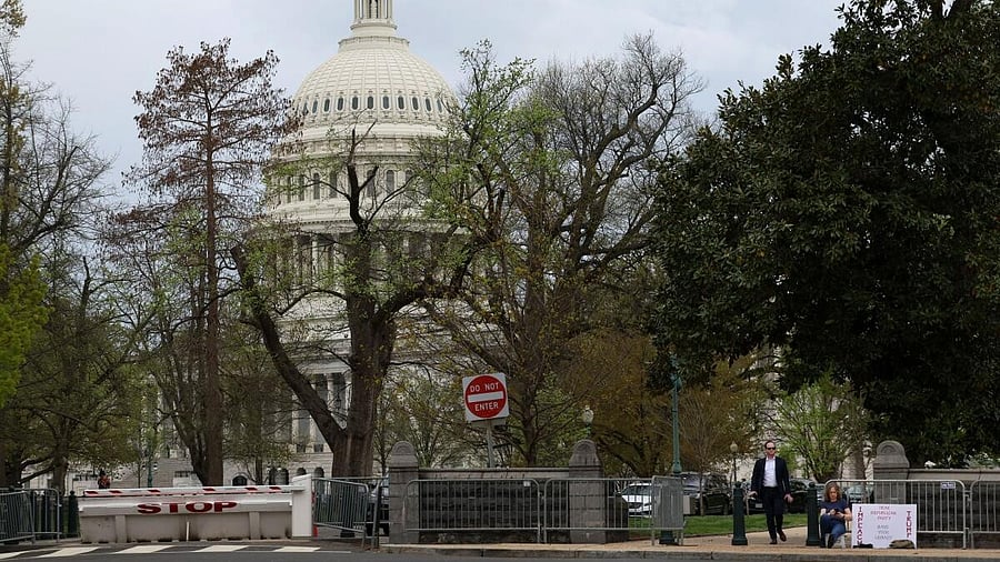 <div class="paragraphs"><p>A woman sits outside the Capitol Hill in Washington.</p></div>